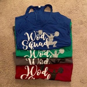 Set of four Racerback Tanks that say “WOD Squad”